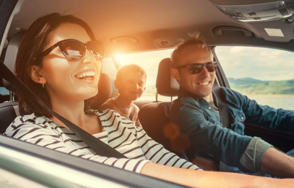 Happy family driving on their way to their spring activity.